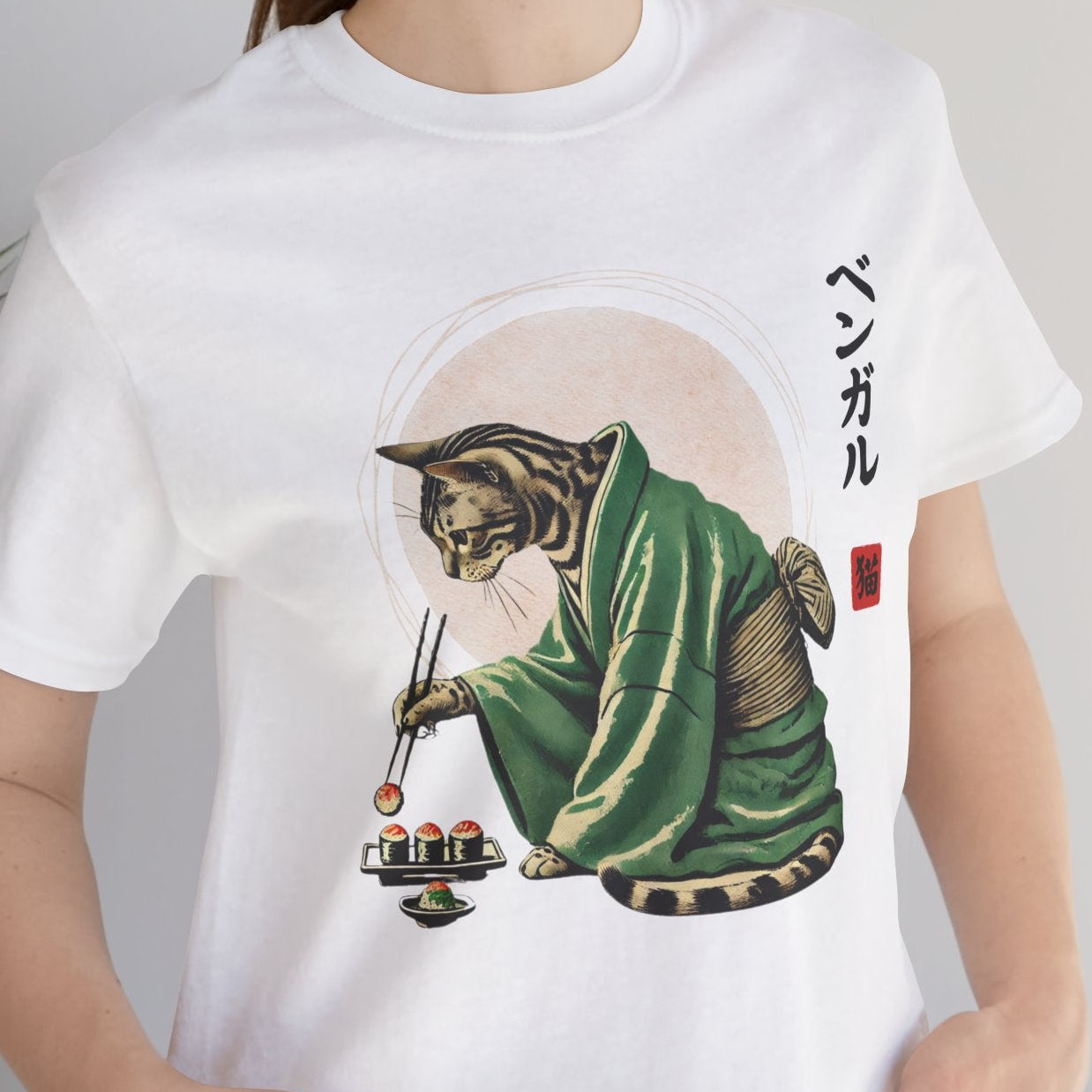 Person wearing a white t-shirt with a tiger design and Japanese text, standing indoors.
