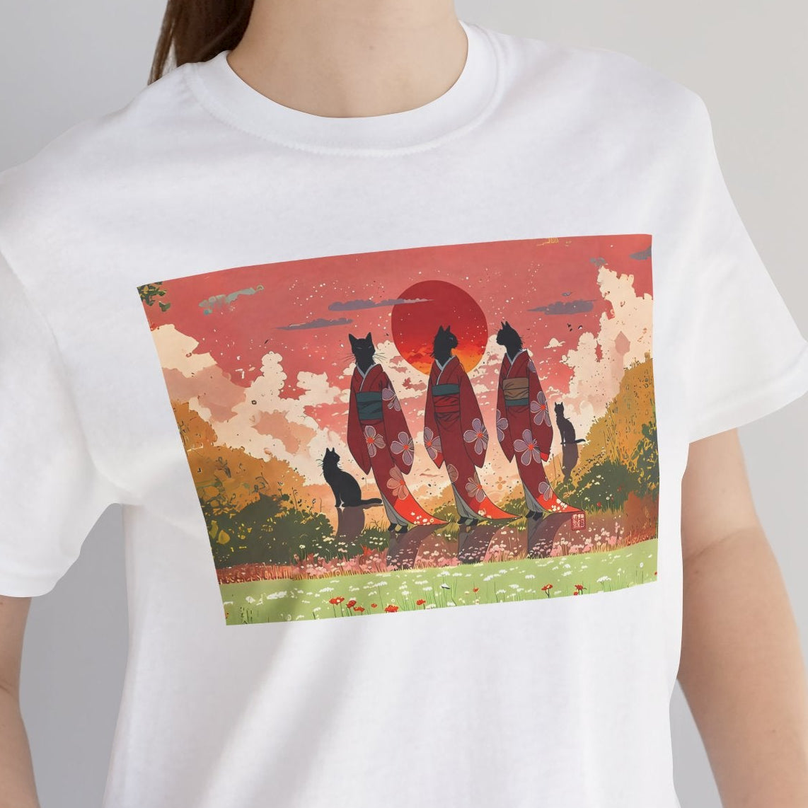 Person wearing a white t-shirt with a colorful graphic design of three people and a sunset.