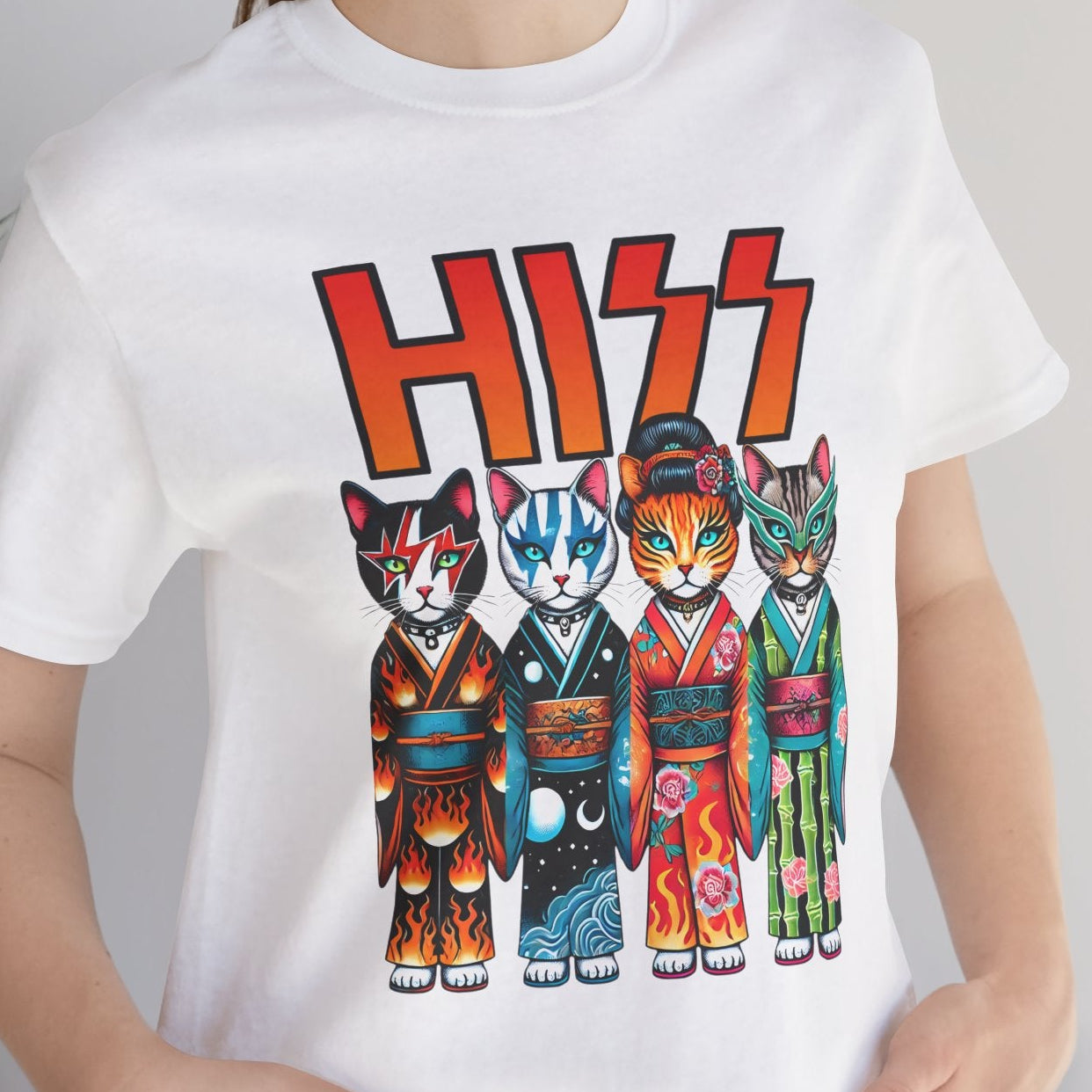 Person wearing a white t-shirt with colorful cat designs and 'HISS' text.