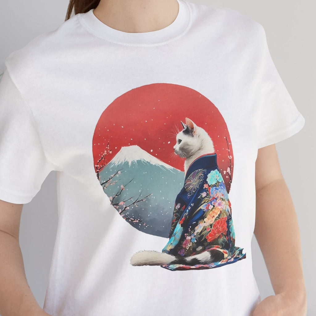 Person wearing a white t-shirt with a cat in a kimono design against a red sun and mountain background.