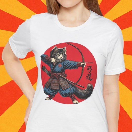 Person wearing a white t-shirt with a graphic design of a cat in a samurai outfit on a red and orange background with cherry blossoms.