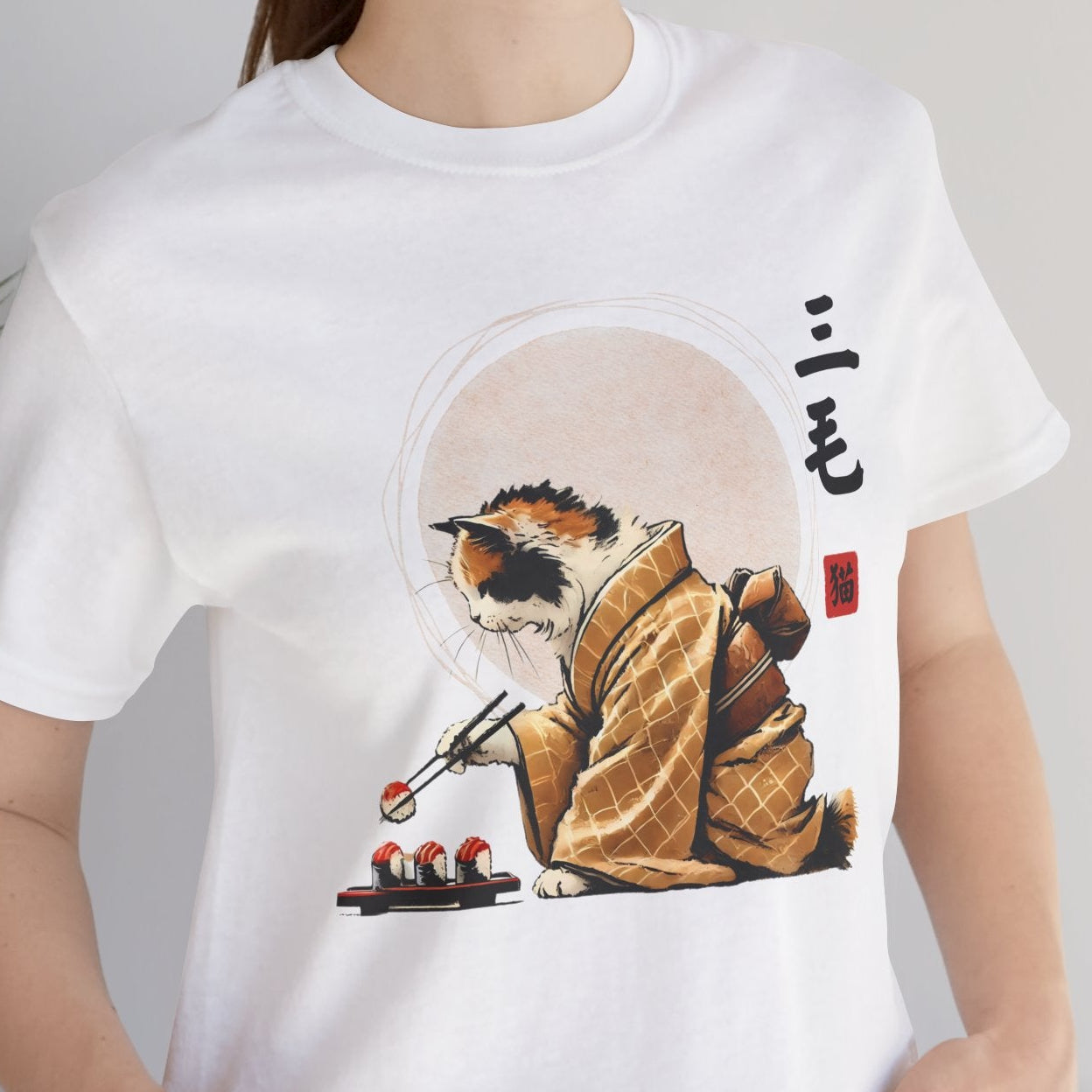 Person wearing a white t-shirt with a graphic design of a cat in a kimono.