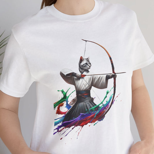 Person wearing a white t-shirt with a colorful graphic design, standing indoors next to a plant.