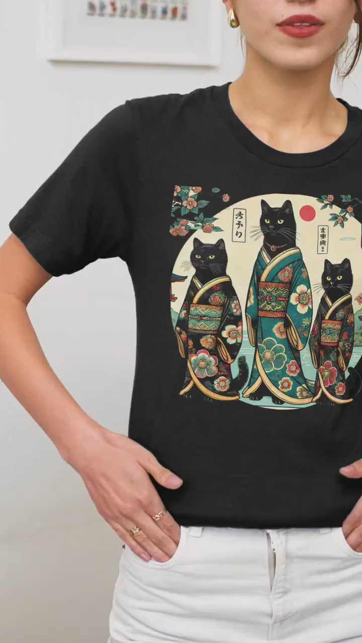 Woman wearing a shirt with 3 black kimono cats.